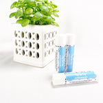 Per Yer Lip - Peppermint Lip Balm. Image shows three lip balms with green plant in background.