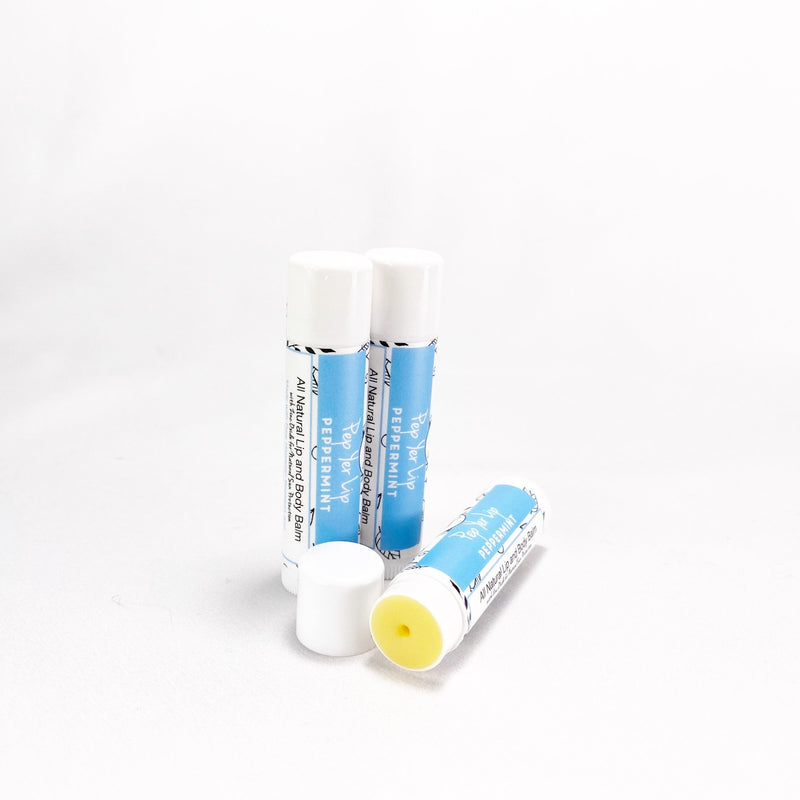 Per Yer Lip - Peppermint Lip Balm. Image shows three lip balms without cap to show balm